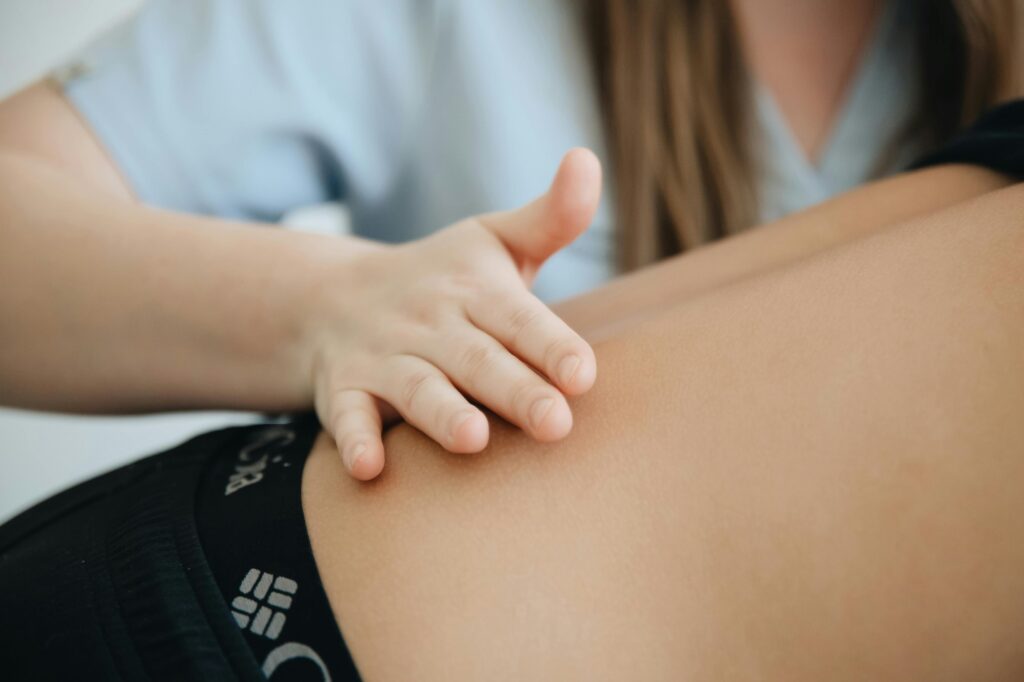 Close-up of a physiotherapist providing a back massage to a patient in a clinic.