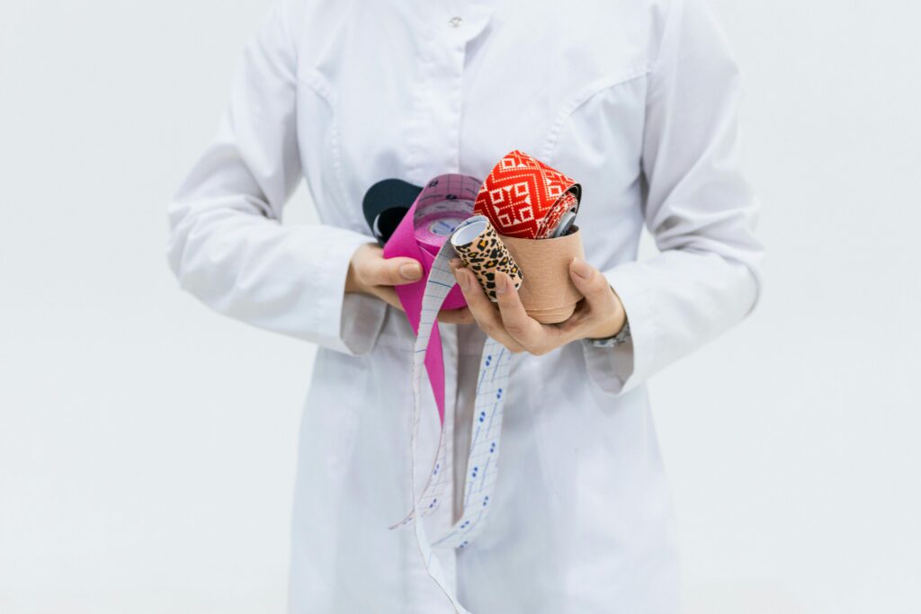 Healthcare professional holding colorful kinesiology tape for medical therapy and treatment.